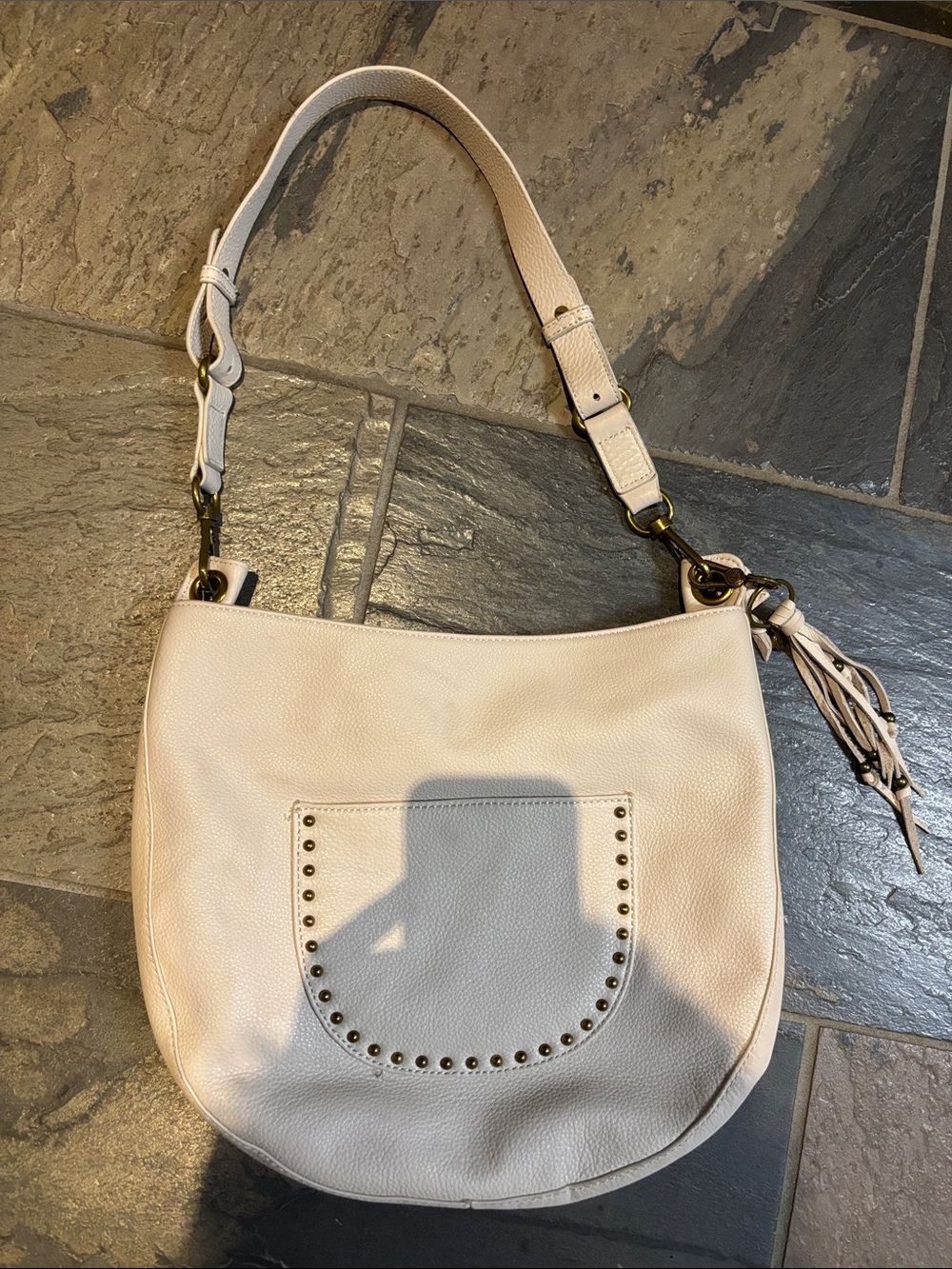 The Sak Cream Pebbled Leather Hobo Shoulder Bag with Tassel
